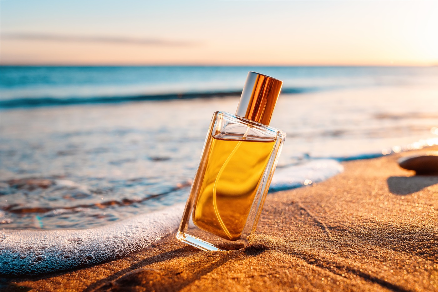 Damskie perfumy na lato na plaży przy morzu.